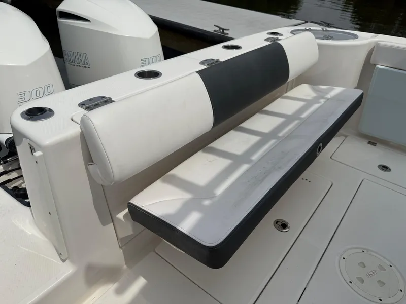 Slide: The Image of 2019 Robalo R302 Center Console boat with dual Yamaha 300 engines and cushioned seating. - 19