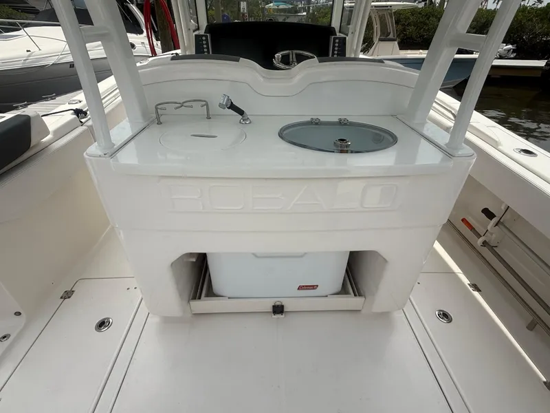 Slide: The Image of 2019 Robalo R302 Center Console boat interior with sink and storage compartment. - 21