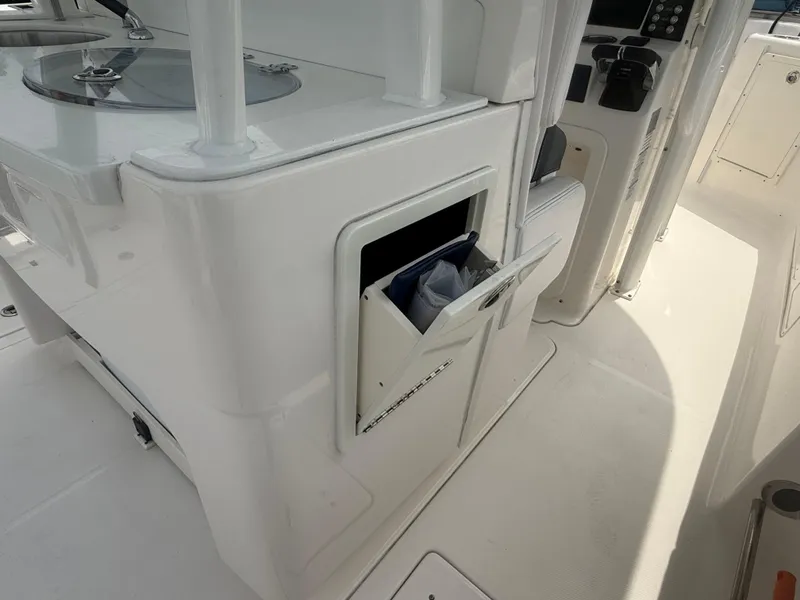 Slide: The Image of 2019 Robalo R302 Center Console interior with storage compartment open. - 28