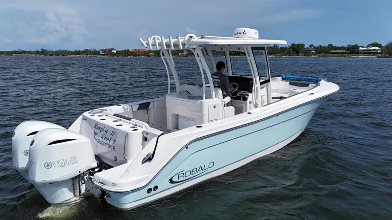 Slide: The Image of 2019 Robalo R302 Center Console boat cruising on open water. - 3