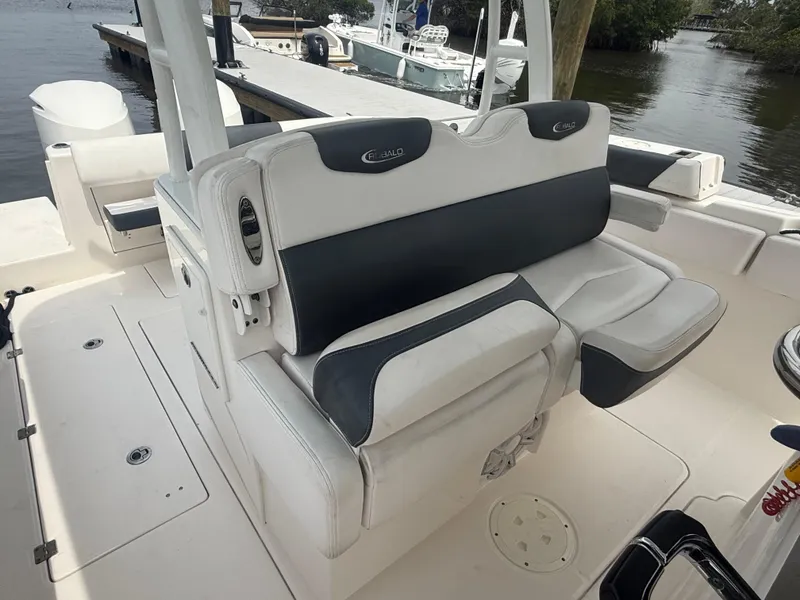 Slide: The Image of 2019 Robalo R302 Center Console boat interior with cushioned seating and sleek design. - 33