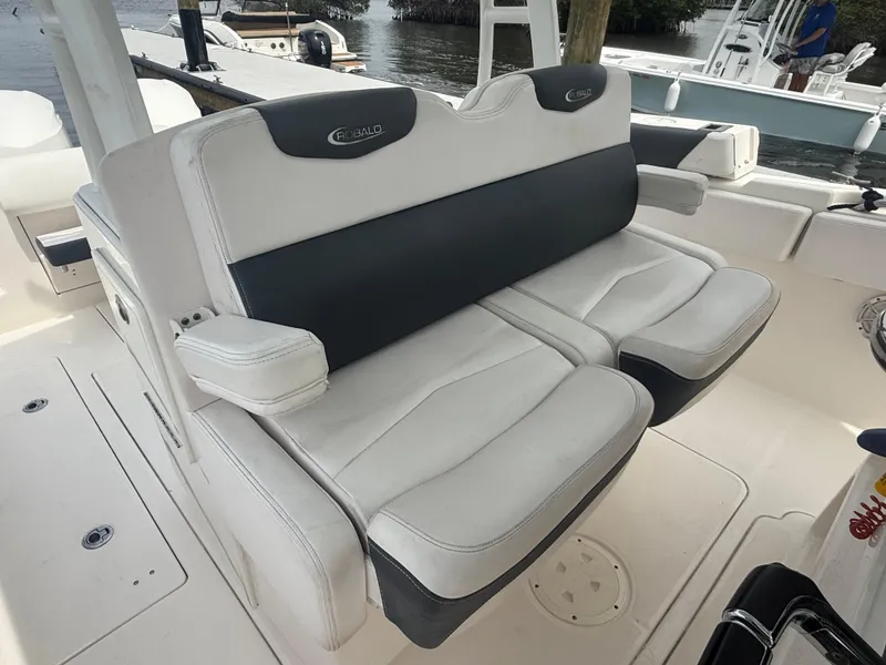 Slide: The Image of 2019 Robalo R302 Center Console boat seating, featuring plush, dual-tone cushioned seats. - 34