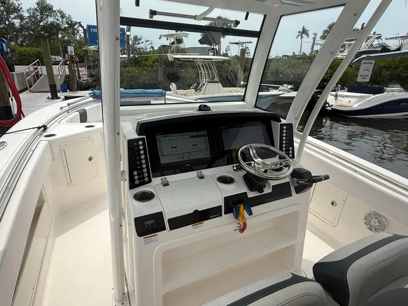 Slide: The Image of 2019 Robalo R302 Center Console boat interior with modern dashboard and steering wheel. - 35