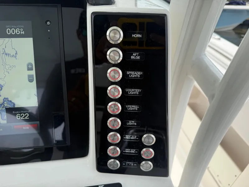 Slide: The Image of Control panel of 2019 Robalo R302 Center Console boat with labeled switches. - 41
