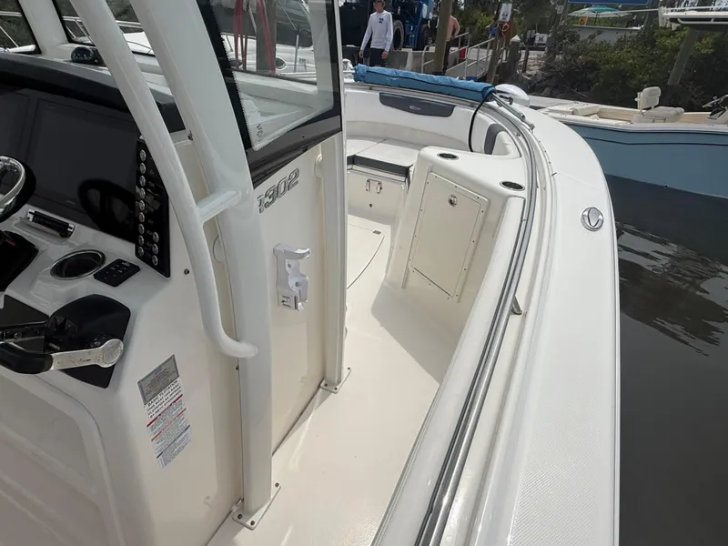 Slide: The Image of 2019 Robalo R302 Center Console boat interior with helm and seating area. - 49