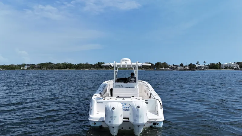 Slide: The Image of 2019 Robalo R302 Center Console boat on open water, clear sky background. - 7