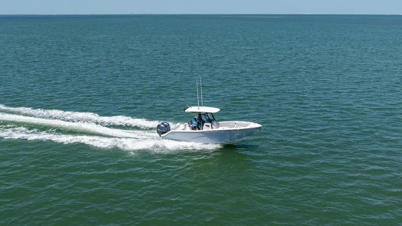 Slide: The Image of 2022 Sea Fox 268 Commander cruising on open water, creating a wake. - 13