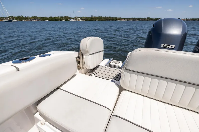 Slide: The Image of 2022 Sea Fox 268 Commander boat interior with seating and outboard motor on a sunny day. - 19