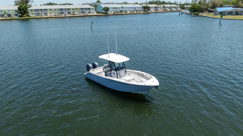 Slide: The Image of 2022 Sea Fox 268 Commander boat on calm water near residential area. - 2