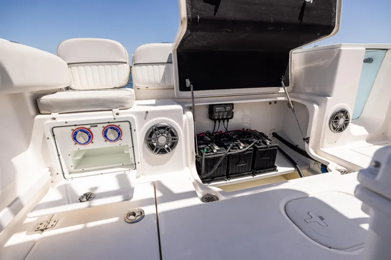 Slide: The Image of 2022 Sea Fox 268 Commander boat interior with open storage compartments and battery setup. - 26