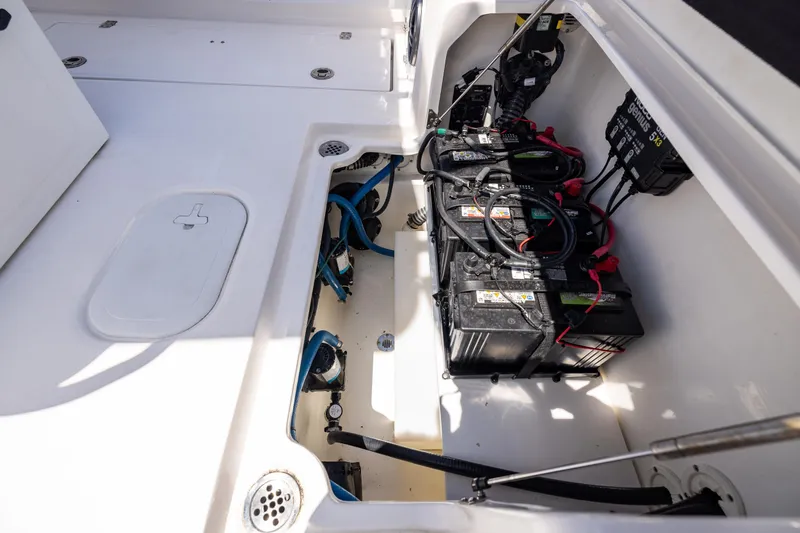 Slide: The Image of 2022 Sea Fox 268 Commander boat battery compartment with wiring and storage space. - 28