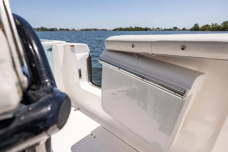 Slide: The Image of 2022 Sea Fox 268 Commander boat interior with seating, on a sunny day by the water. - 35