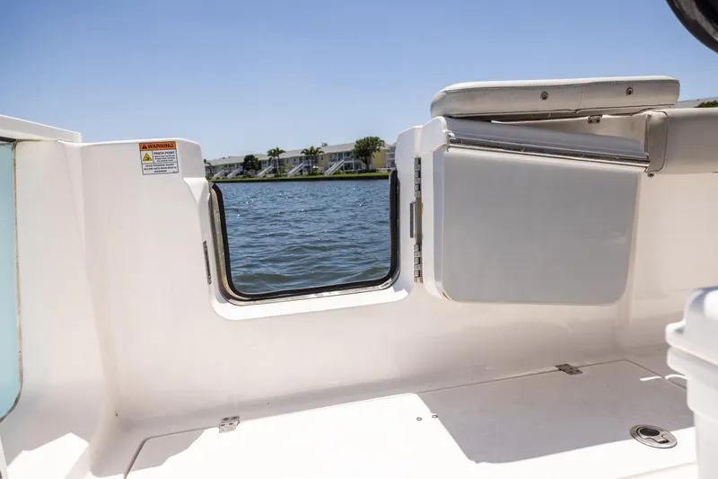 Slide: The Image of 2022 Sea Fox 268 Commander boat interior with open side door, overlooking water. - 36