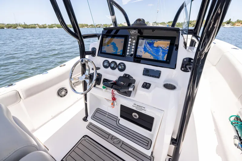 Slide: The Image of 2022 Sea Fox 268 Commander boat dashboard with navigation screens on a sunny day. - 45