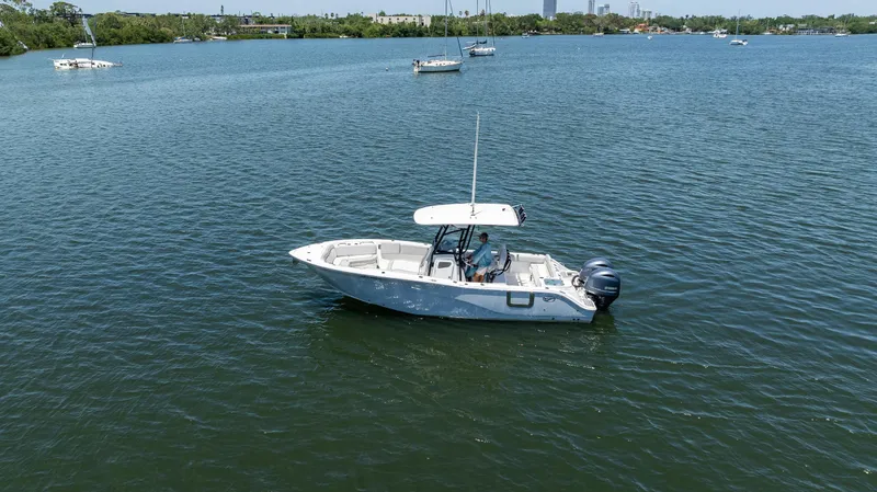 Slide: The Image of 2022 Sea Fox 268 Commander boat on calm water, surrounded by other boats. - 5