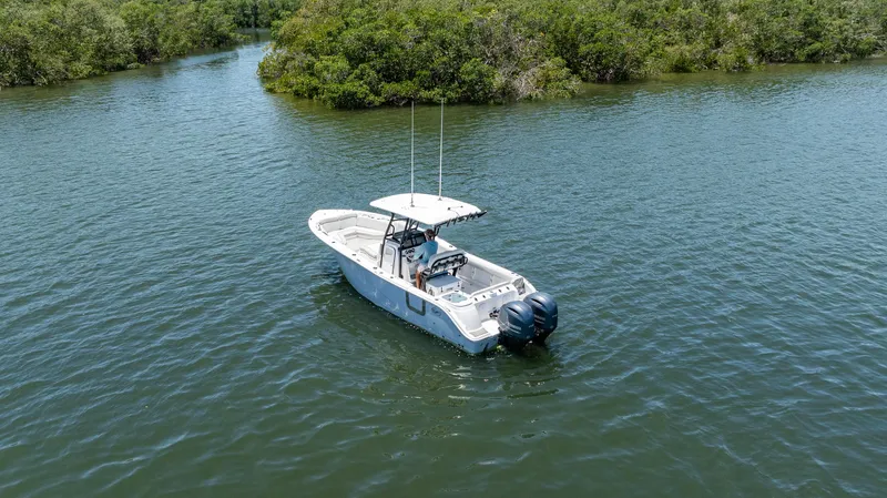 Slide: The Image of 2022 Sea Fox 268 Commander boat on calm water surrounded by lush greenery. - 6