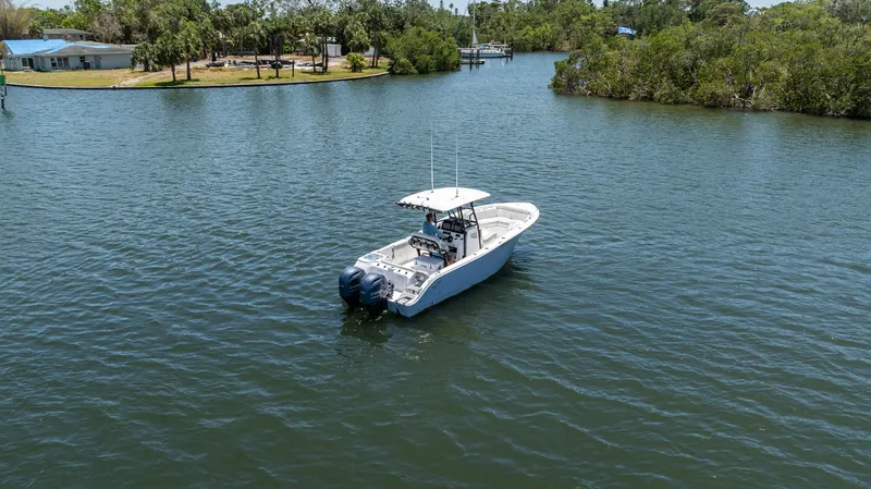 Slide: The Image of 2022 Sea Fox 268 Commander boat cruising on a serene lake surrounded by lush greenery. - 8