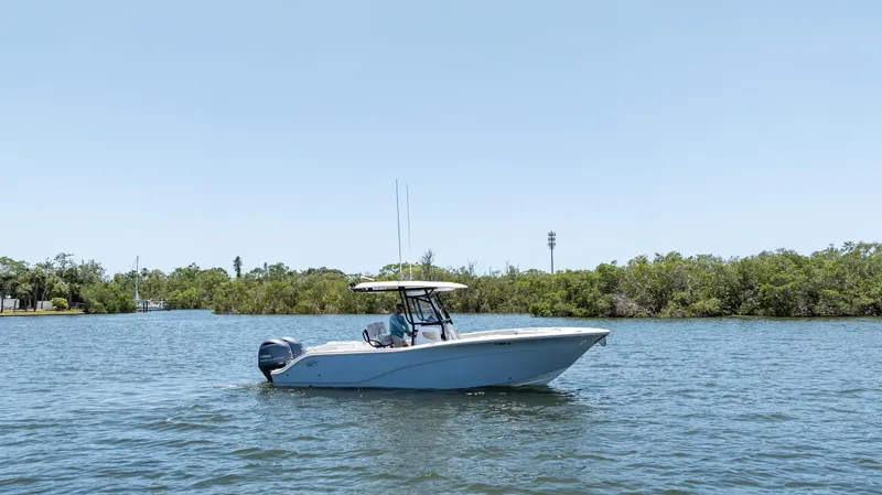 Slide: The Image of 2022 Sea Fox 268 Commander boat on calm water near lush shoreline. - 9