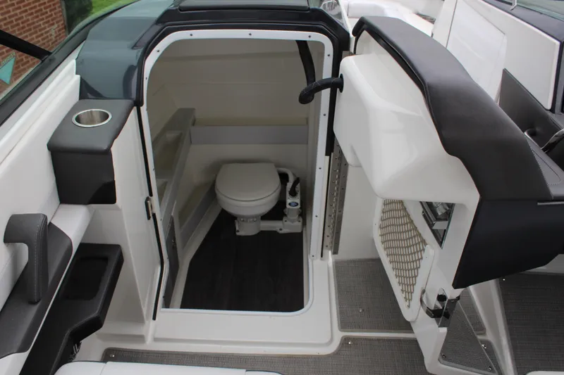 Slide: The Image of 2021 Formula 290 Bowrider boat interior with compact marine toilet and sleek design. - 12