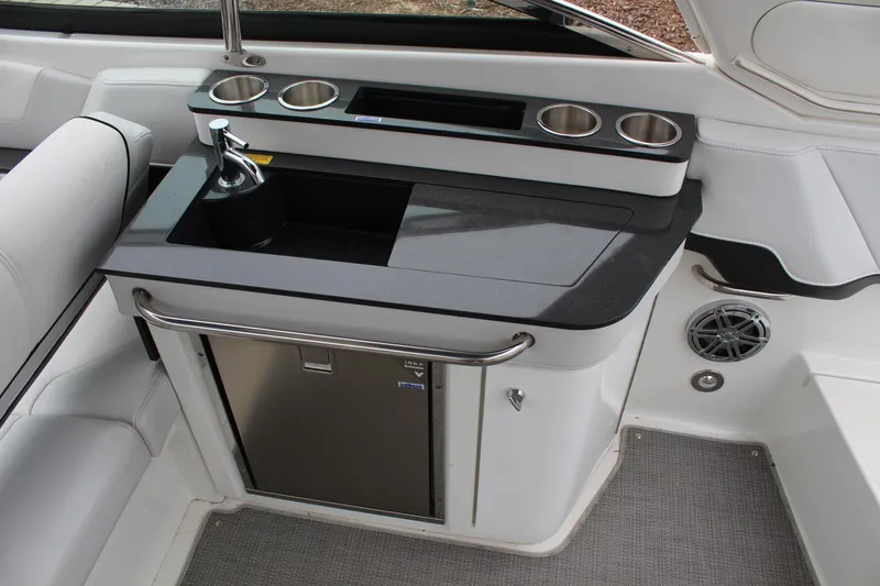 Slide: The Image of 2021 Formula 290 Bowrider boat interior with kitchenette and stainless steel sink. - 17