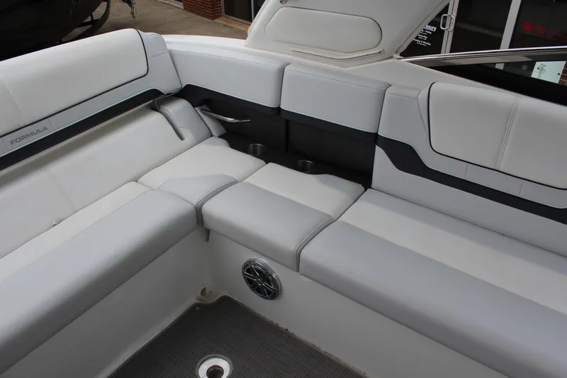 Slide: The Image of 2021 Formula 290 Bowrider interior with white cushioned seating and speaker detail. - 9