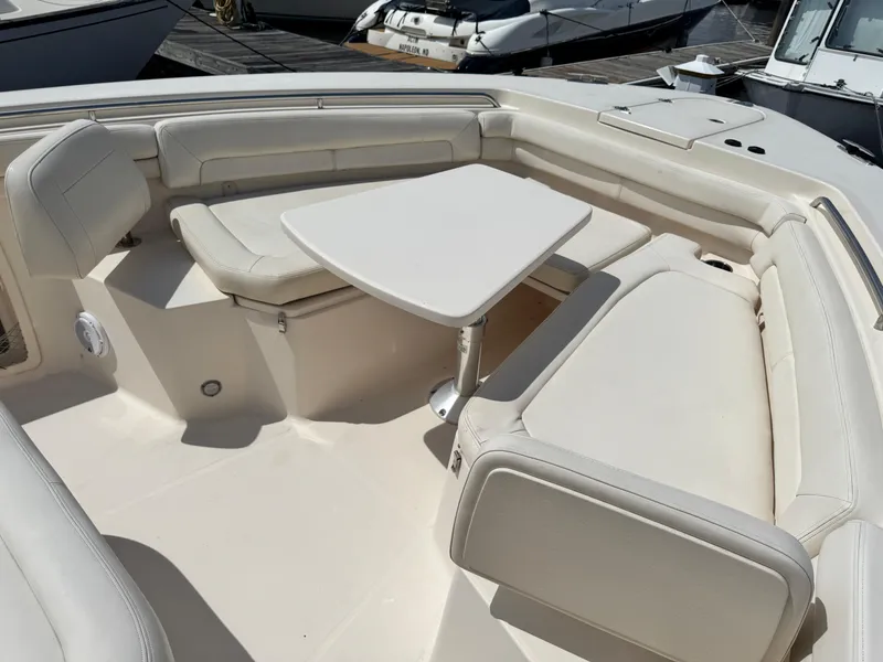 Slide: The Image of 2017 Grady-White Canyon 376 boat interior with cushioned seating and table. - 11