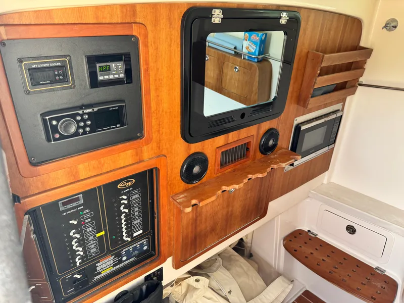 Slide: The Image of 2017 Grady-White Canyon 376 cabin interior with control panels and wooden accents. - 17