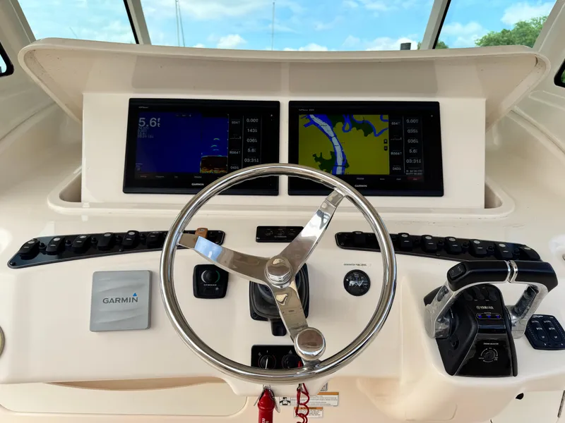 Slide: The Image of Helm of 2017 Grady-White Canyon 376 with Garmin displays and steering wheel. - 19