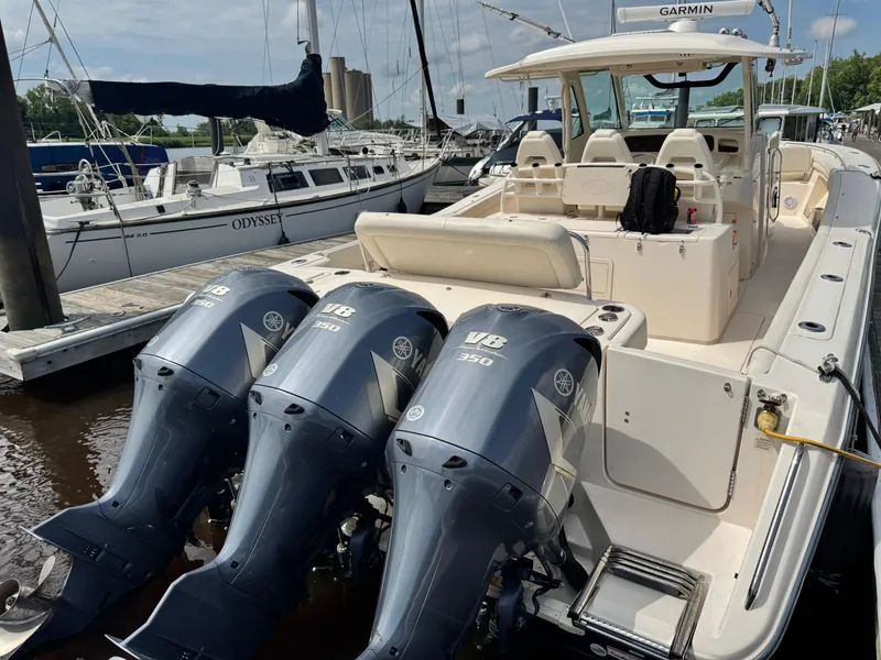 Slide: The Image of 2017 Grady-White Canyon 376 boat with triple Yamaha outboard engines docked at a marina. - 21
