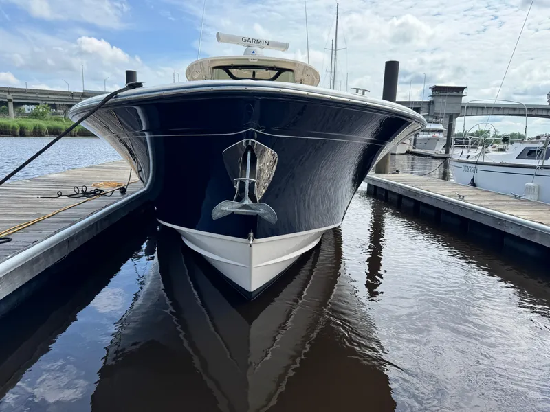 Slide: The Image of 2017 Grady-White Canyon 376 boat docked, front view with anchor, calm water. - 22