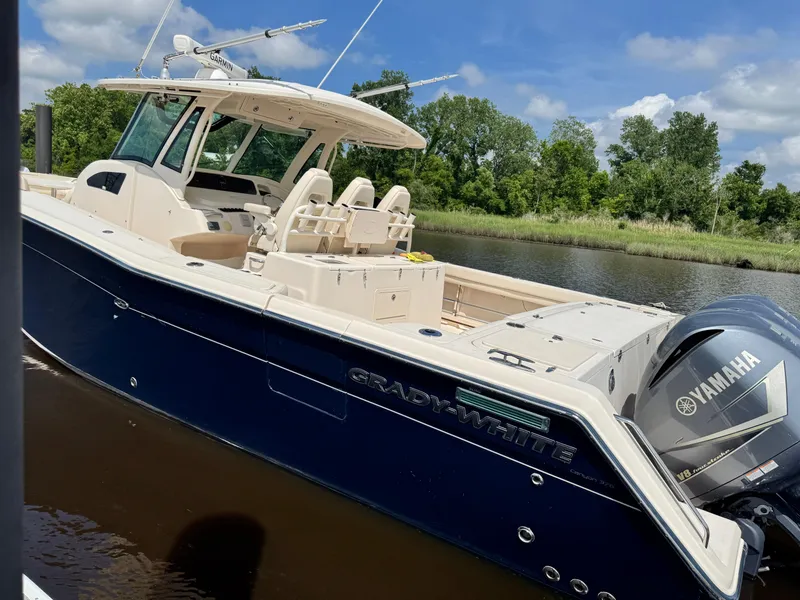 Slide: The Image of 2017 Grady-White Canyon 376 boat with Yamaha engine, docked on a sunny day. - 3