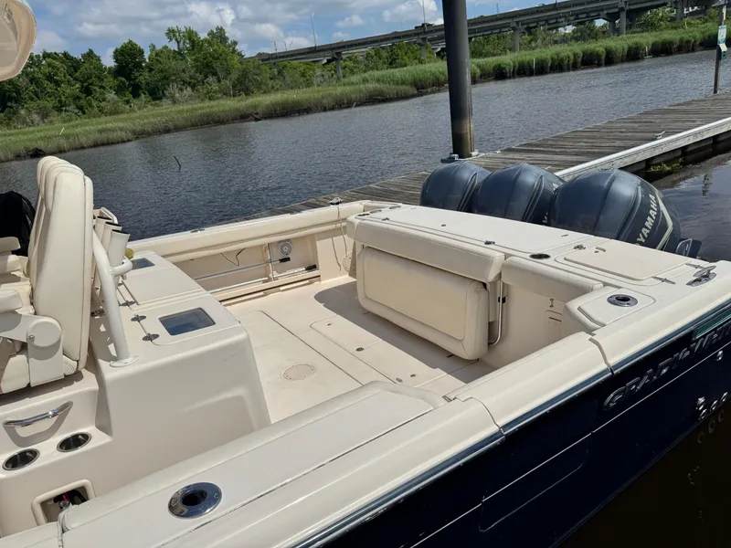 Slide: The Image of 2017 Grady-White Canyon 376 boat docked by a river with triple outboard engines. - 5