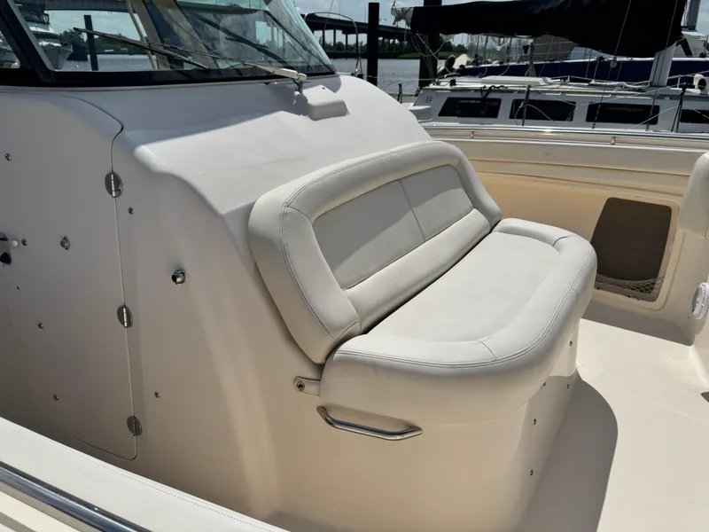 Slide: The Image of 2017 Grady-White Canyon 376 boat with cushioned seating in a marina setting. - 7