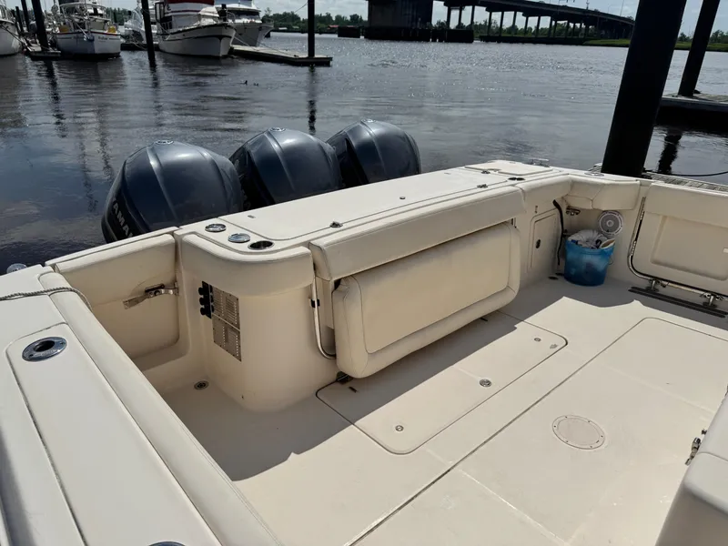 Slide: The Image of 2017 Grady-White Canyon 376 boat with triple engines docked by a bridge. - 8