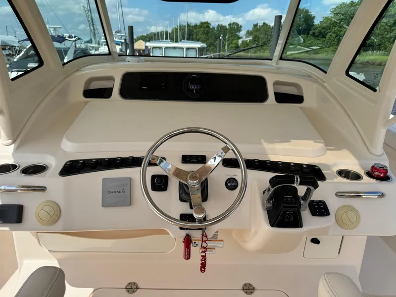 Slide: The Image of Helm of 2017 Grady-White Canyon 376 boat with steering wheel and controls. - 9