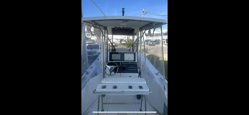 Slide: The Image of 1993 KenCraft CHALLENGER 250CC boat cockpit with steering wheel and navigation equipment. - 10