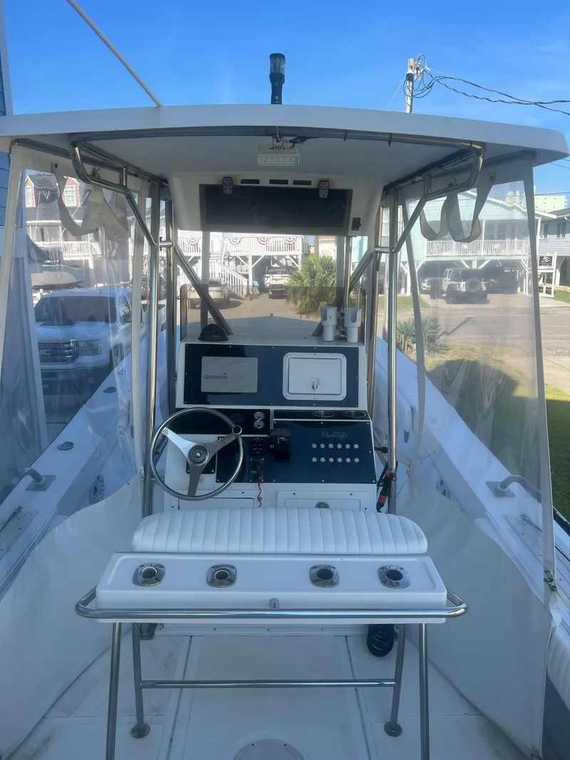 Slide: The Image of 1993 KenCraft Challenger 250CC boat cockpit with steering wheel and control panel. - 11