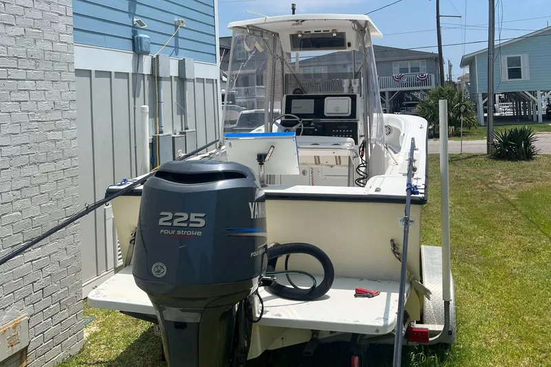 Slide: The Image of 1993 KenCraft Challenger 250CC boat with Yamaha 225 engine, parked outdoors. - 13