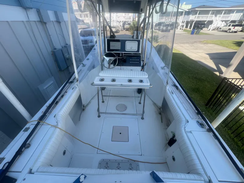 Slide: The Image of 1993 KenCraft Challenger 250CC boat interior with steering console and seating. - 14