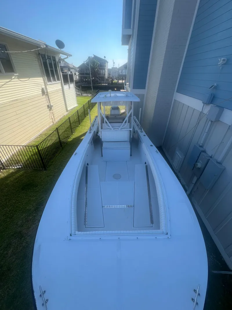 Slide: The Image of 1993 KenCraft Challenger 250CC boat docked beside a blue building. - 15