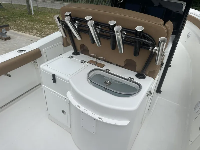 Slide: The Image of 2020 Sea Hunt Gamefish 30 boat interior with rod holders and storage compartments. - 19