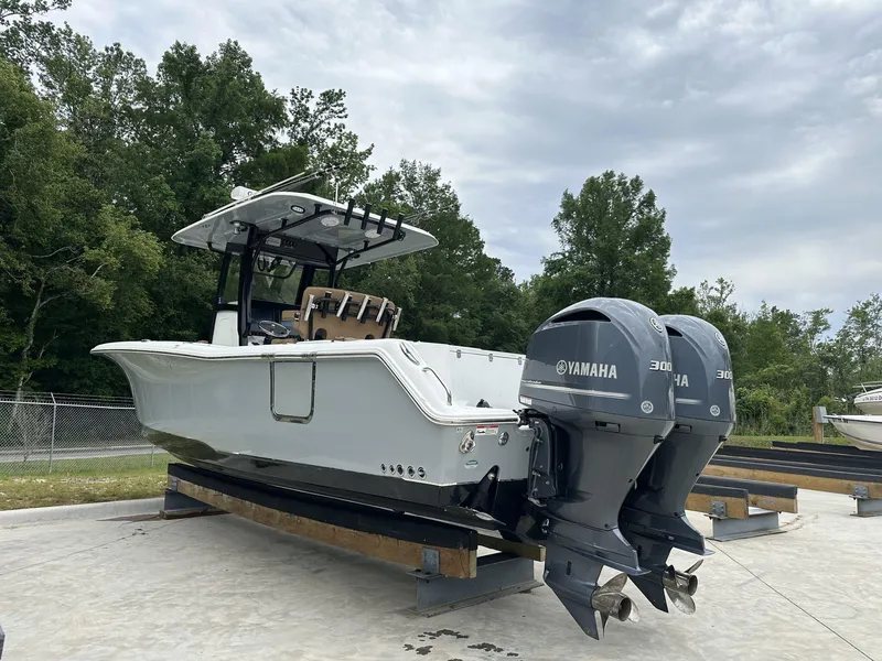 Slide: The Image of 2020 Sea Hunt Gamefish 30 with Coffin Box, dual Yamaha engines, parked outdoors. - 8