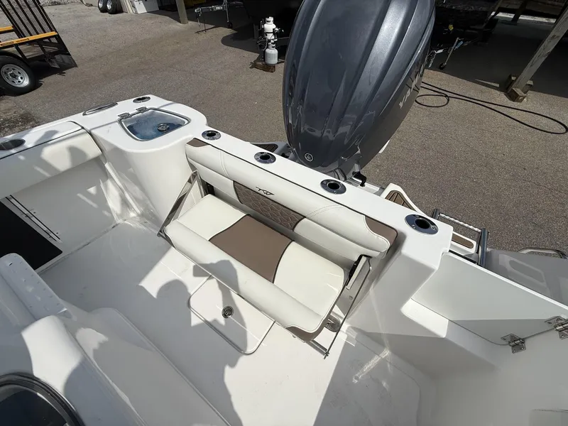 Slide: The Image of 2025 Tidewater 232 CC Adventure boat interior with seating and motor. - 6