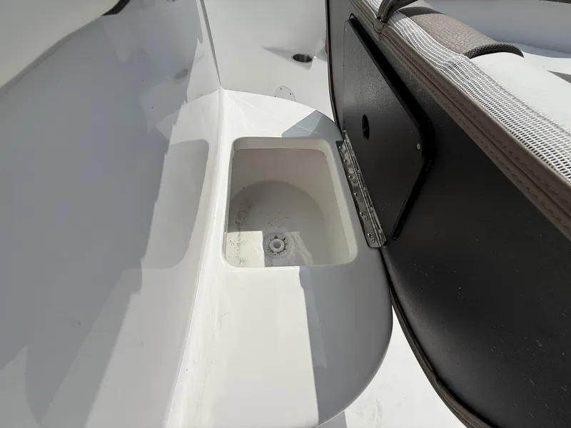 Slide: The Image of 2025 Tidewater 232 CC Adventure boat storage compartment detail. - 13