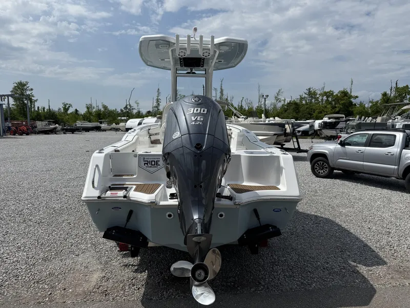 Slide: The Image of 2025 Tidewater 232 CC Adventure boat with Seakeeper Ride, rear view in a marina. - 4