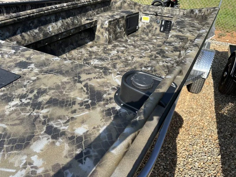 Slide: The Image of 2025 Excel Viper F4 1751 boat with camouflage design, parked on gravel. - 4