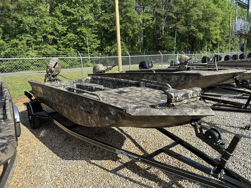 Slide: The Image of 2025 Excel Viper F4 1751 boat with camouflage design on a trailer, parked outdoors. - 1