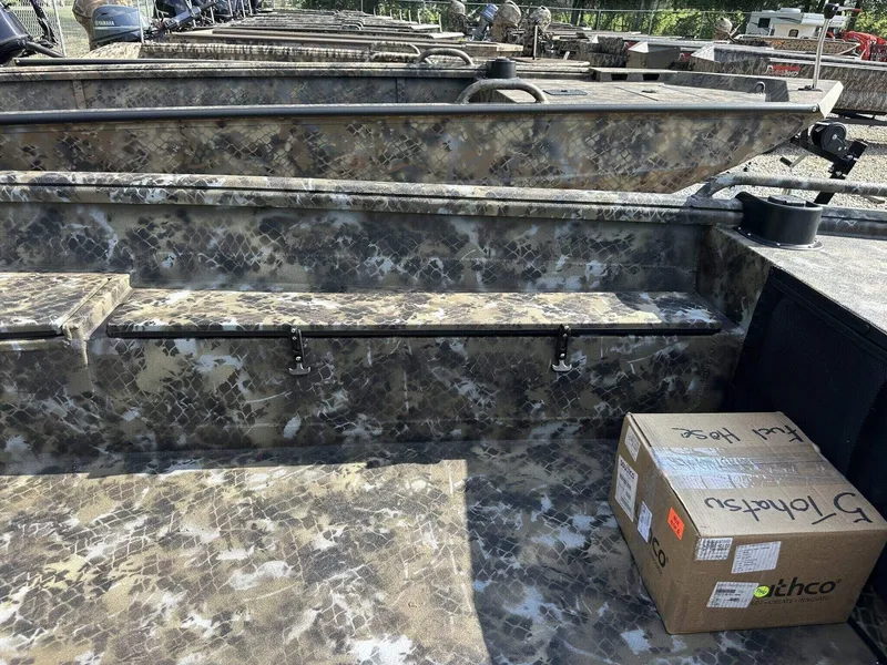 Slide: The Image of 2025 Excel Viper F4 1751 boat interior with camouflage design and a cardboard box. - 9