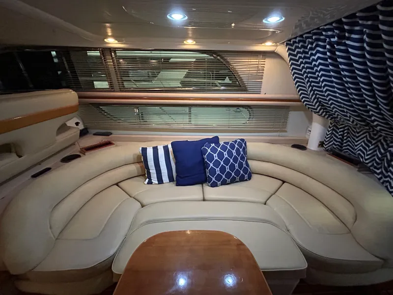 Slide: The Image of Luxurious interior of 2000 Sealine F44 yacht with plush seating and nautical-themed cushions. - 13