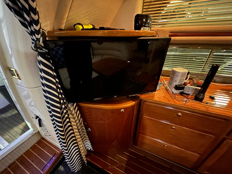 Slide: The Image of Interior of 2000 Sealine F44 yacht with TV and wooden cabinetry. - 14
